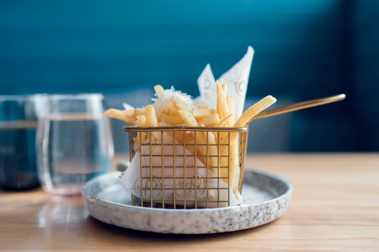 Chef plating a dish in a softly lit kitchen